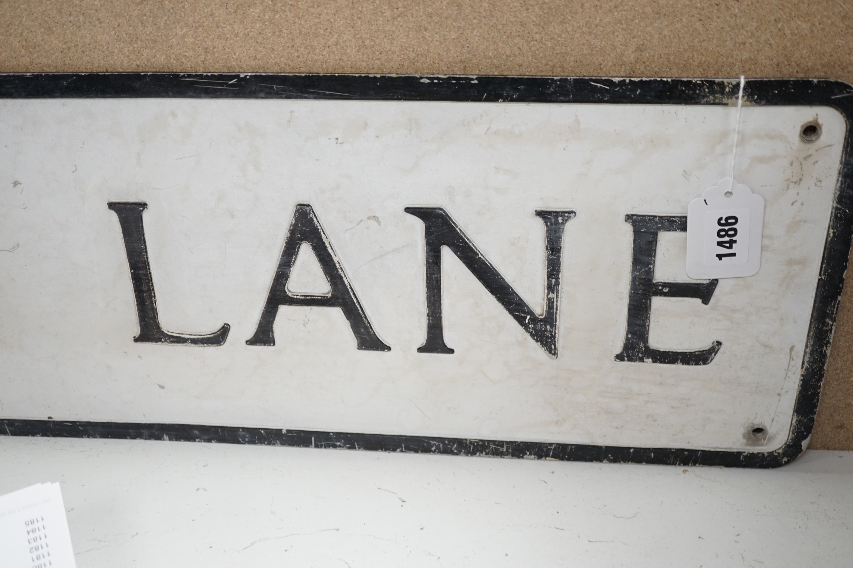 An enamel advertising sign: A.V. Welch & Co, and an Eastport Lane aluminium street sign, latter 105cm long